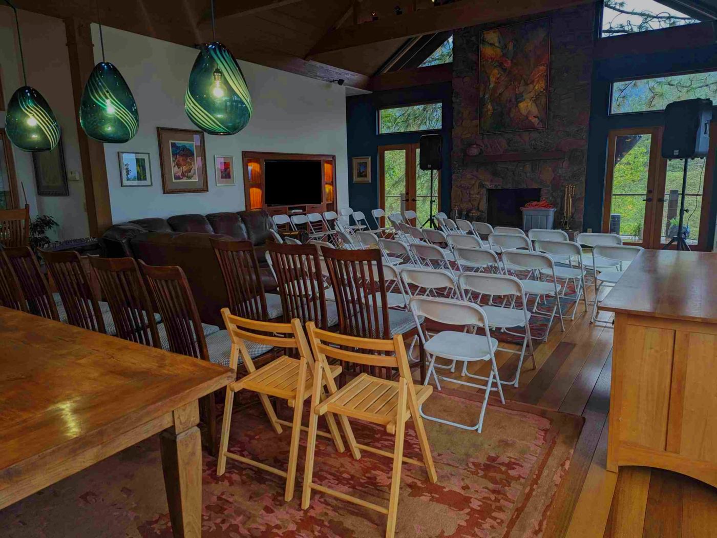 Hummingbird MPC concert venue — intimate concert setup with art, stone fireplace and teal glass pendants, Ashland Oregon